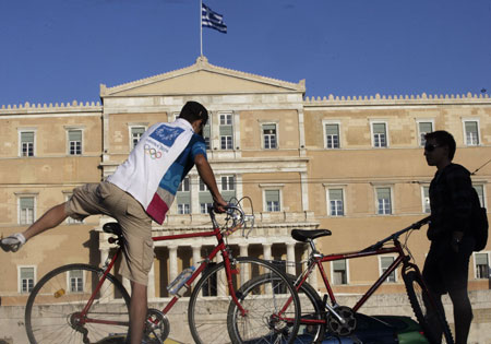 Two young men ride bicycles as an act to response to the World Car Free Day in Athens, capital of Greece, September 22, 2009.
