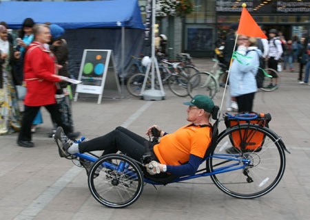 A man rides on a recumbent bicycle as part of an act to celebrate World Car Free Day in Helsinki, capital of Finland, September 22, 2009.