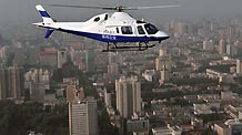 A police helicopter hovers over the city during its routine patrol aviation for the tightening the orderly security guarding for the grand celebration of the National Day, in Zhengzhou, central China's Henan Province, September 23, 2009