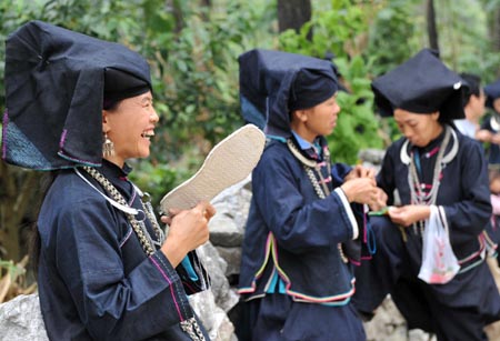 Women of Dark Cloth Zhuang stitch soles in Napo county, southwest China's Guangxi Zhuang Autonomous Region, September 23, 2009.
