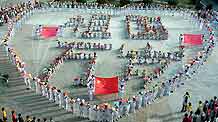 Pupils and their teachers line up in formations of heart pattern and Characters literally Long Lives to Homeland, while singing song of Ode to Homeland, on campus of Gongyuanlu Elementary School, in Zhijiang City, central China's Hubei Province, September 24, 2009. Well over 1,100 pupils and teachers gather together for a song party to express their reverence and blessings to the homeland prior to the forthcoming 60th anniversary of the founding of the People's Republic of China.