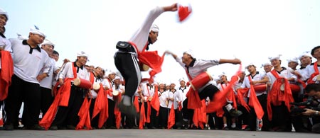 Members of waist drum dance team from Ansai County of northwest China's Shaanxi Province perform during their rehearsal for the upcoming National Day massive celebration, in Beijing, September 25, 2009.