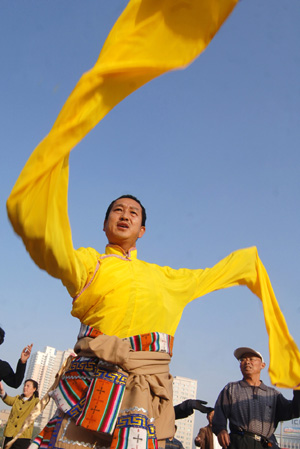 A man of the Tibet ethnic group performs Guozhuang, a Tibetan Bonfire Dance, in Xining, capital of northwest China's Qinghai Province, September 24, 2009. 