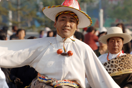 A man of the Tibet ethnic group performs Guozhuang, a Tibetan Bonfire Dance, in Xining, capital of northwest China's Qinghai Province, September 24, 2009. 