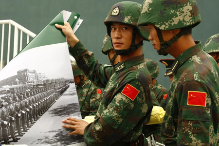 Soldiers display photos at the Parade Photo Exhibition in Beijing, China, September 24, 2009.