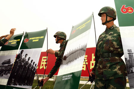 Soldiers display photos at the Parade Photo Exhibition in Beijing, China, September 24, 2009.