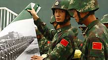 Soldiers display photos at the Parade Photo Exhibition in Beijing, China, September 24, 2009.