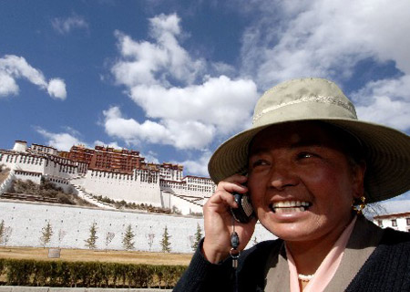 A resident of Lhasa, capital of southwest China's Tibet Autonomous Region, talks on her mobile in this file photo taken on March 28, 2007. 
