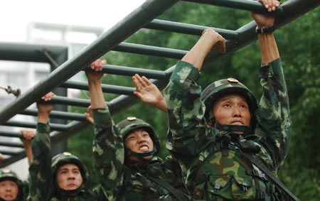 Chinese armed policemen practise during an anti-terrorism training to ensure the stability during the National Day holidays, in Hefei, capital of east China's Anhui Province, September 25, 2009.