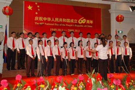 Members of a local Chinese merchants association sing a song in an evening to celebrate the 60th anniversary of founding of the People's Republic of China in Phnom Penh, capital of Cambodia, September 25, 2009.