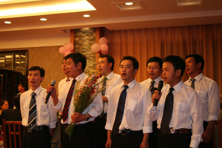 Members of Chinese geology survey team sing a song in a gathering to celebrate the 60th anniversary of founding of the People's Republic of China in Tananarive, capital of Madagascar, September 25, 2009. 