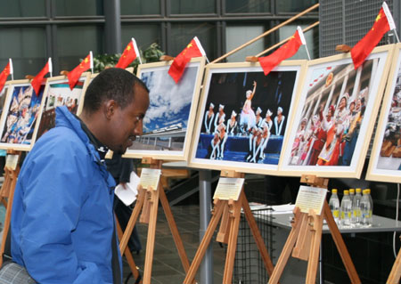 A visitor has a look at a photo displayed in an exhibition to mark the 60th anniversary of founding of the People's Republic of China in Haaga-Helia University of Applied Sciences, Helsinki, capital of Finland, September 25, 2009. 