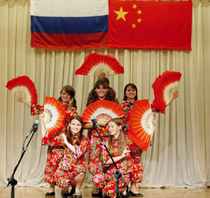 Russian girls perform Chinese dance in an evening sponsored by Confucius Institute of Moscow University to celebrate the 60th anniversary of founding of the People's Republic of China in Moscow, capital of Russia, September 25, 2009.