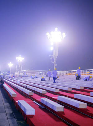 Workers assemble the temporary reviewing stands on the both sides of Tiananmen rostrum for China&apos;s 60th National Day celebrations in Beijing, capital of China, September 25, 2009. 