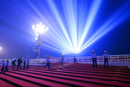 Workers assemble the temporary reviewing stands on the both sides of Tiananmen rostrum for China&apos;s 60th National Day celebrations in Beijing, capital of China, September 25, 2009. 