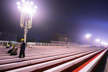 Workers assemble the temporary reviewing stands on the both sides of Tiananmen rostrum for China&apos;s 60th National Day celebrations in Beijing, capital of China, September 25, 2009. 