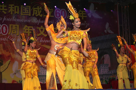Overseas Chinese perform the thousand-hand Bodhisattva dance during a celebration to mark the upcoming 60th anniversary of the founding of the People's Republic of China, in Bucharest, Romania, September 26, 2009.