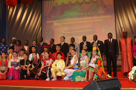 Performers and government officials from China and Benin pose for a group photo after a celebration to mark the upcoming 60th anniversary of the founding of the People's Republic of China, in Cotonou, Benin, September 26, 2009. 