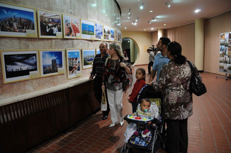 Visitors watch a photo exhibition held to celebrate the upcoming 60th anniversary of the founding of the People's Republic of China, in Tunis, Tunisia, September 26, 2009.