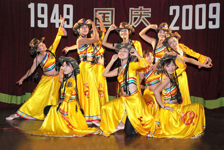 Teachers of a eastern language school perform during a celebration to mark the upcoming 60th anniversary of the founding of the People's Republic of China, in Yangon, Myanmar, September 26, 2009.