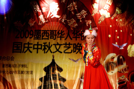 A Chinese teacher of a Confucius Institute dances during a celebration to mark the upcoming 60th anniversary of the founding of the People's Republic of China, in Mexico City, capital of Mexico, September 26, 2009. 