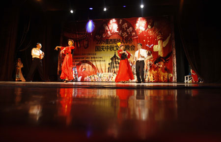 Overseas Chinese dance during a celebration to mark the upcoming 60th anniversary of the founding of the People's Republic of China, in Mexico City, capital of Mexico, September 26, 2009. 