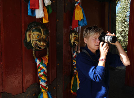 A German tourist takes photo in the street in Lhasa, capital of southwest China's Tibet Autonomous Region, on September 27, 2009.