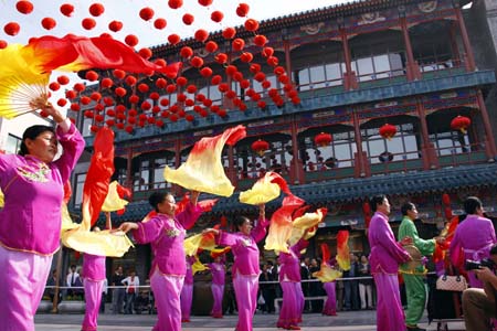 Citizens perform traditional dances to celebrate the opening of Qianmen Street, one of Beijing's oldest commercial areas, in Beijing, capital of China, September 9. 