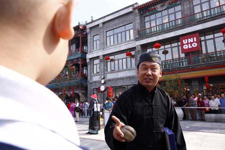 A tourist visits Qianmen Street, one of Beijing's oldest commercial areas, in Beijing, capital of China, September 28, 2009. 