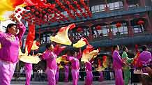 Citizens perform traditional dances to celebrate the opening of Qianmen Street, one of Beijing's oldest commercial areas, in Beijing, capital of China, September 9.
