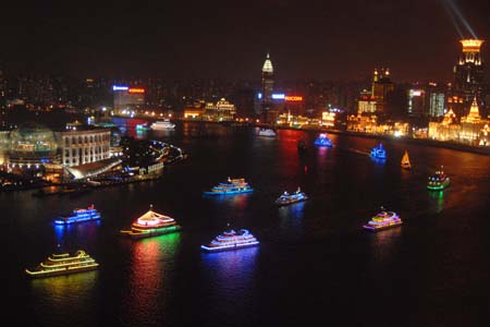 Festooned ships cruise on the Huangpujiang River, during a festival fireworks show together with the festooned ships cruise over the Huangpujiang River to intensify the happy festival atmosphere to usher in the forthcoming 60th anniversary of the founding of the People's Republic of China, in Shanghai, east China, September 28, 2009.