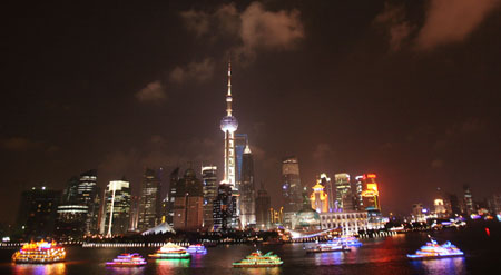 A range of festooned ships cruise on the Huangpujiang River, during a festival fireworks show together with the festooned ships cruise over the Huangpujiang River to intensify the happy festival atmosphere to usher in the forthcoming 60th anniversary of the founding of the People's Republic of China, in Shanghai, east China, September 28, 2009.