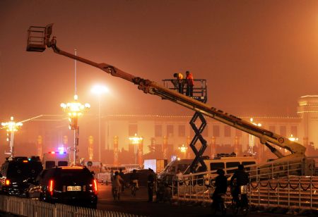 Media technicians adjust the equipment which will be used at the National Day celebrations at Tian&apos;anmen Square, Beijing, September 29, 2009.