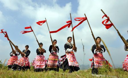 People of Miao ethnic group perform lusheng dance in Longli County, southwest China's Guizhou Province, September 29, 2009.