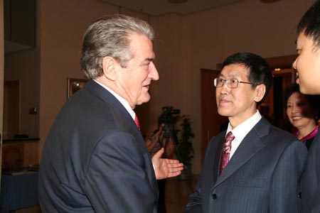 Prime Minister of Albania Sali Berisha (1st L) talks to Chinese Ambassador to Albania Wang Junling (2nd L) during a reception to celebrate the 60th anniversary of the founding of the People's Republic of China, in Tirana, Albania, on September 29, 2009.