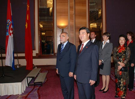 Chinese ambassador to the Republic of Croatia Wu Lianqi (2nd L) and Croatian President Stjepan Mesic (1st L) attend a reception to celebrate the 60th anniversary of the founding of the People's Republic of China, in Zagreb, capital of Croatia, on September 29, 2009. 