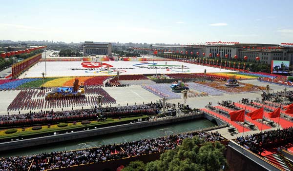 The background phalanxes form the images of the emblems of 2008 Beijing Olympic and Paralympic Games, during the celebrations for the 60th anniversary of the founding of the People's Republic of China, in central Beijing, capital of China, October 1, 2009. 