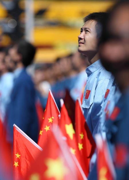 Students holding national flags take part in a parade of the celebrations for the 60th anniversary of the founding of the People&apos;s Republic of China, on Chang&apos;an Street in central Beijing, capital of China, October 1, 2009.