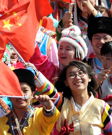 People wave national flags during the celebrations for the 60th anniversary of the founding of the People&apos;s Republic of China, in Beijing, capital of China, October 1, 2009. 