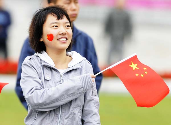 Local residents watch live television program of the Beijing parade ceremony of the 60th anniversary of the founding of the People's Republic of China, in downtown Changchun, capital of northeast China's Jilin Province, October 1, 2009. 