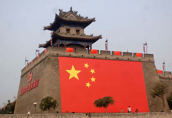 A national flag is hung on the southeastern side of the wall of the ancient city of Xi'an for a celebration for the 60th anniversary of the founding of the People's Republic of China in Xi'an, capital of northwest China's Shaanxi Province, October 1, 2009.