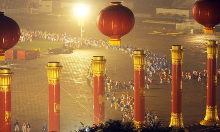 People participating in the massive celebrations take their positions in front of Tian&apos;anmen in the early morning in Beijing, on Oct. 1, 2009.(Xinhua/Xu Jiajun)