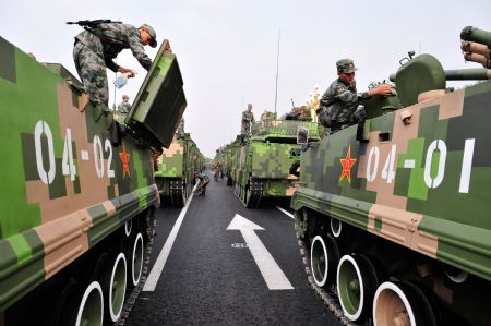 Soldiers prepare to take part in the celebrations for the 60th anniversary of the founding of the People's Republic of China, in Beijing, capital of China, Oct. 1, 2009. (Xinhua/Yang Guang)