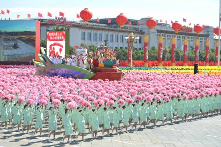 A float featuring "population" takes part in a parade of the celebrations for the 60th anniversary of the founding of the People