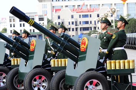 Soldiers of the Chinese People's Armed Police Force fire 60 gun salute at the start of the celebrations for the 60th anniversary of the founding of the People's Republic of China, near the Tian'anmen Square in central Beijing, capital of China, Oct. 1, 2009. (Xinhua/Ren Yong)