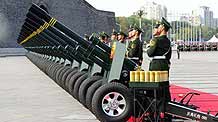 Soldiers of the Chinese People's Armed Police Force fire 60 gun salute at the start of the celebrations for the 60th anniversary of the founding of the People's Republic of China, near the Tian'anmen Square in central Beijing, capital of China, October 1, 2009.