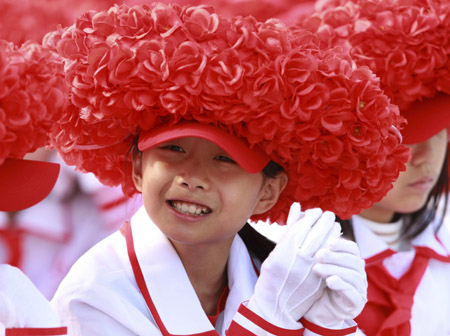 A student smiles while attending the celebrations for the 60th anniversary of the founding of the People&apos;s Republic of China on the Tian&apos;anmen Square in central Beijing, capital of China, Oct. 1, 2009.(Xinhua/Pang Xinglei)