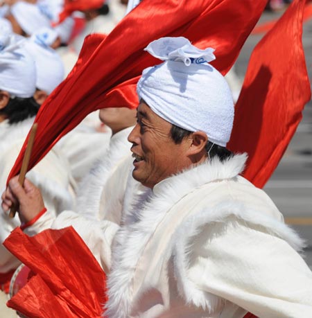 People play drums in a parade of the celebrations for the 60th anniversary of the founding of the People's Republic of China, on Chang'an Avenue in central Beijing, capital of China, Oct. 1, 2009. (Xinhua/Li Wen)