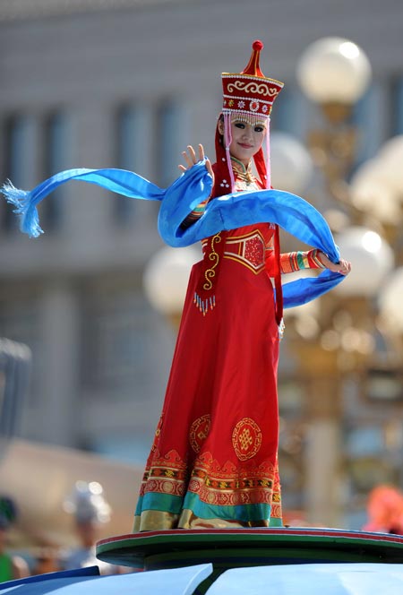 A girl waves hands on top of a float when taking part in a parade of the celebrations for the 60th anniversary of the founding of the People's Republic of China, on Chang'an Street in central Beijing, capital of China, Oct. 1, 2009. (Xinhua/Zhang Ling) 