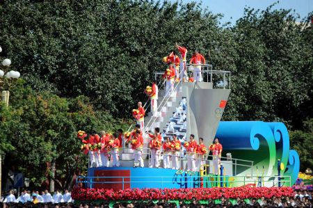 The float expressing "physical culture development" takes part in a parade of the celebrations for the 60th anniversary of the founding of the People
